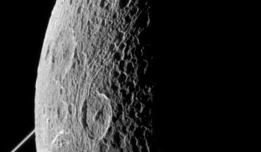 This image was taken in visible light with the Cassini spacecraft narrow-angle camera on June 16, 2015. The bright rings of Saturn can be seen at left. North on Dione is up and rotated 44 degrees to the left. Image credit: NASA / JPL-Caltech / Space Science Institute.