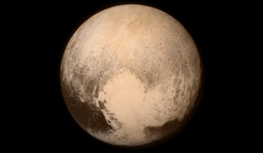 Pluto nearly fills the frame in this image from NASA’s New Horizons spacecraft, taken on July 13, 2015, when the spacecraft was 476,000 miles (768,000 km) from the dwarf planet’s surface. This is the last and most detailed image sent to Earth before the spacecraft’s closest approach to Pluto on July 14. The color image has been combined with lower-resolution color information from the Ralph instrument that was acquired earlier on July 13. This view is dominated by the large, bright feature informally named the ‘heart,’ which measures around 1,000 miles (1,600 km) across. The heart’s diameter is about the same distance as from Denver to Chicago, in America’s heartland. The heart borders darker equatorial terrains, and the mottled terrain to its east (right) are complex. However, even at this resolution, much of the heart’s interior appears remarkably featureless-possibly a sign of ongoing geologic processes. Image credit: NASA / Johns Hopkins University Applied Physics Laboratory / Southwest Research Institute.