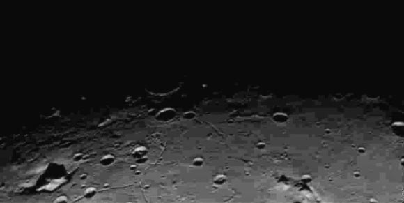 This new image of an area on Charon has a strange feature (shown in the left bottom corner of the image). Image credit: NASA / Johns Hopkins University Applied Physics Laboratory / Southwest Research Institute.