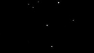 This image of Pluto (center) was taken on July 14, 2015 from a distance of 2.4 billion miles (3.9 billion km). Image credit: NASA / JPL-Caltech / Space Science Institute.