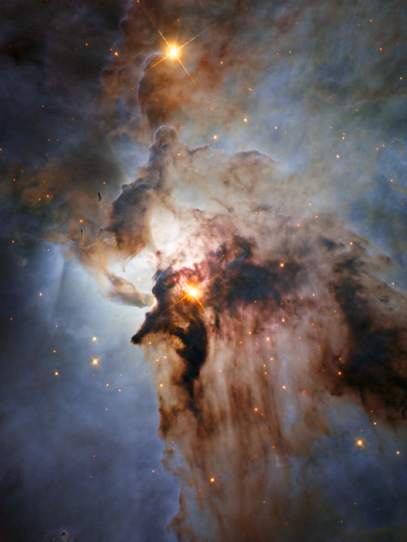 This Hubble image shows the center of the Lagoon Nebula. The region is filled with intense winds from hot stars, churning funnels of gas, and energetic star formation, all embedded within an intricate haze of gas and pitch-dark dust. Image credit: NASA / ESA / J. Trauger, JPL.