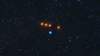 The asteroid 31 Euphrosyne glides across a field of background stars in this time-lapse view from NASA’s WISE spacecraft. WISE obtained the images used to create this view over a period of about a day around May 17, 2010, during which it observed the asteroid four times. The moving asteroid appears as a string of orange dots because it is much cooler than the distant background stars. Stars have temperatures in the thousands of degrees, but the asteroid is cooler than room temperature. Thus the stars are represented by shorter wavelength blue colors in this view, while the asteroid is shown in longer wavelength reddish colors. Image credit: NASA / JPL-Caltech.