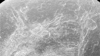 This image from NASA’s Cassini spacecraft shows a part of Dione’s surface that is covered by linear, curving features, called chasmata. The Voyager spacecrafts observed Dione in 1980 showing a complex surface structure, with wispy features on its trailing hemisphere. The nature of these features was unclear until 2004, when the Cassini spacecraft showed that they weren’t surface deposits of frost, as some had suspected, but rather a pattern of bright icy cliffs among myriad fractures. One possibility is that this stress pattern may be related to Dione’s orbital evolution and the effect of tidal stresses over time. This view looks toward the trailing hemisphere of Dione. Cassini obtained the image with its narrow-angle camera on April 11, 2015. The view was acquired at a distance of 68,000 miles (110,000 km) from Dione. North on Dione is up. Image credit: NASA / JPL-Caltech / Space Science Institute.