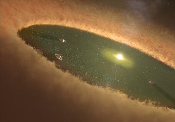 This artist’s concept of a young solar system shows gas giants forming first, while the gas nebula is present. Prof Martin Duncan and co-authors used computer simulations to nail down how Jupiter and Saturn evolved in our own Solar System. These calculations show that the cores of gas giants likely formed by gradually accumulating a population of ‘planetary pebbles’ - icy objects about a foot in diameter. Image credit: NASA / JPL-Caltech.