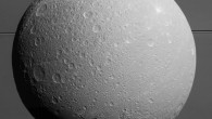 This view from Cassini looks toward Dione, with giant Saturn and its rings in the background, just prior to the mission’s final close approach to the moon on August 17. The view was acquired at distances ranging from approximately 106,000 miles (170,000 km) to 39,000 miles (63,000 km) from the icy moon and at a Sun-Dione-spacecraft, or phase, angle of 35 degrees. At lower right is the large, multi-ringed impact basin Evander, which is about 220 miles (350 km) wide. The canyons of Padua Chasma, features that form part of Dione’s bright, wispy terrain, reach into the darkness at left. Scientists combined nine visible light images to create this mosaic view: eight from Cassini’s narrow-angle camera and one from the wide-angle camera, which fills in an area at lower left. The scene is an orthographic projection centered on terrain at 0.2 degrees north latitude, 179 degrees west longitude on Dione. An orthographic view is most like the view seen by a distant observer looking through a telescope. North on Dione is up. Image credit: NASA / JPL-Caltech / Space Science Institute.