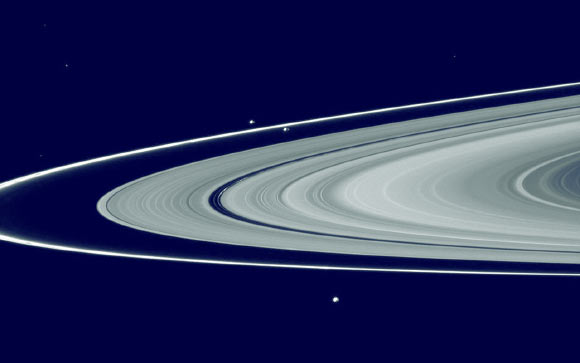 This composite image shows Saturn’s main rings, the F ring, and its shepherd satellites: the narrow F ring is located just outside of the outer edge of the main rings; slightly above and to the left of the center of the image are the shepherd satellites Prometheus (inner orbit) and Pandora (outer orbit). Image credit: NASA.