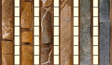 These rocks, recovered by the Ocean Drilling Program on board the drilling vessel JOIDES Resolution, are from the Earth’s upper mantle that underwent intense alteration by heated seawater. The rocks show a systematic change in color from rusty brown (top) to green and black (bottom), reflecting the chemical gradients across the fluid mixing zone. These chemical gradients played a key role in supporting microbes with chemical energy and the substrates they needed to thrive. Fossilized microbes were found in white veins consisting of the minerals calcite and brucite. Image credit: Ocean Drilling Program.
