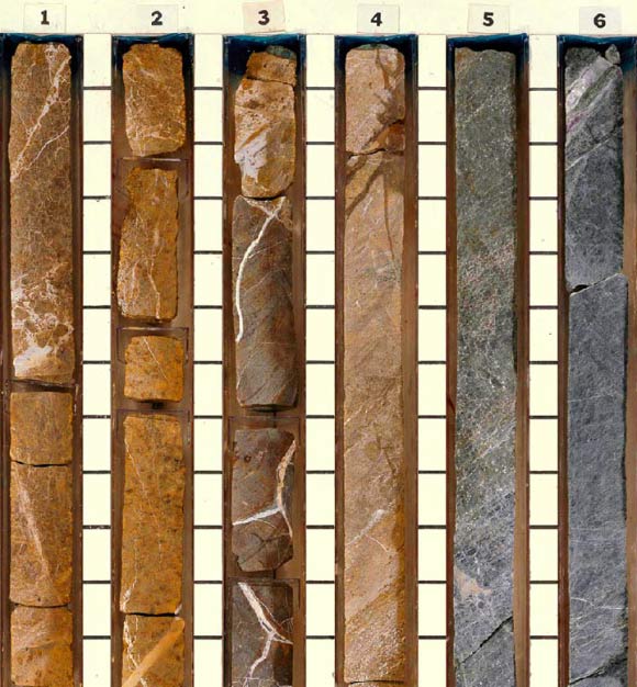These rocks, recovered by the Ocean Drilling Program on board the drilling vessel JOIDES Resolution, are from the Earth’s upper mantle that underwent intense alteration by heated seawater. The rocks show a systematic change in color from rusty brown (top) to green and black (bottom), reflecting the chemical gradients across the fluid mixing zone. These chemical gradients played a key role in supporting microbes with chemical energy and the substrates they needed to thrive. Fossilized microbes were found in white veins consisting of the minerals calcite and brucite. Image credit: Ocean Drilling Program.