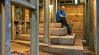 IAA archaeologist Dr Joe Uziel sitting atop the stepped structure. Image credit: Shai Halevy / Israel Antiquities Authority.
