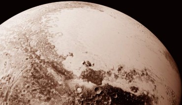 This view of Pluto, based on the latest images to be downlinked from NASA’s New Horizons spacecraft, shows what you would see if you were approximately 1,100 miles (1,800 km) above Pluto’s equatorial area, looking northeast over the dark, cratered, named Cthulhu Regio toward the bright, smooth, expanse of icy plains called Sputnik Planum. The entire expanse of terrain seen in this image is 1,100 miles (1,800 km) across. Image credit: NASA / Johns Hopkins University Applied Physics Laboratory / Southwest Research Institute.