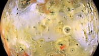 This image from NASA’s Galileo spacecraft shows Io. There are rugged mountains several miles high, layered materials forming plateaus, and many irregular depressions called volcanic calderas. Several of the dark, flow-like features correspond to hot spots, and may be active lava flows. There are no landforms resembling impact craters, as the volcanism covers the surface with new deposits much more rapidly than the flux of comets and asteroids can create large impact craters. The picture is centered on the side of Io that always faces away from Jupiter; north is to the top. Image credit: NASA / JPL / University of Arizona.