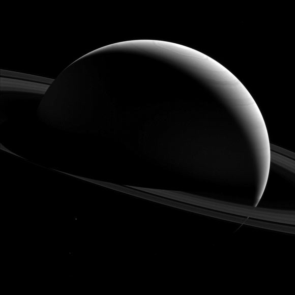 This Cassini image shows the night sides of Saturn and Tethys. Image credit: NASA / JPL-Caltech / Space Science Institute.