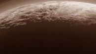 This panoramic image of Pluto highlights dwarf planet’s varied terrains and extended atmosphere. The scene measures 780 miles (1,250 km) across. The smooth expanse of Sputnik Planum (right) is flanked to the west (left) by rugged mountains up to 11,000 feet (3.5 km) high, including Norgay Montes in the foreground and Hillary Montes on the skyline. To the right, east of Sputnik, rougher terrain is cut by apparent glaciers. The backlighting highlights over a dozen layers of haze in the atmosphere of Pluto. The image was taken from a distance of 11,000 miles (18,000 km) to Pluto. Image credit: NASA / Johns Hopkins University Applied Physics Laboratory / Southwest Research Institute.
