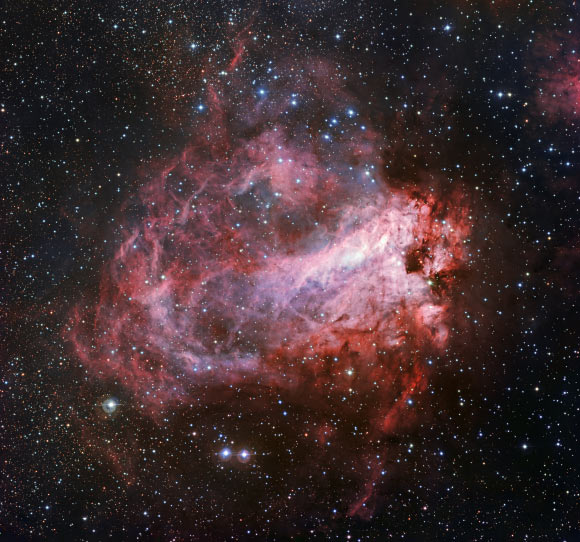 This WFI image shows the spectacular nebula Messier 17, also known as the Omega Nebula or the Swan Nebula. This vast region of gas, dust and hot young stars is approximately 5,920 light-years away. Image credit: ESO.