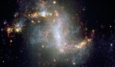 This image shows the spiral galaxy NGC 1313. The very active state of this galaxy is very evident from the image, showing many star formation regions. A great number of supershell nebulae, that is, cocoon of gas inflated and etched by successive bursts of star formation, are visible. The green nebulosities are regions emitting in the ionized oxygen lines and may harbour clusters with very hot stars. This composite image is based on images obtained with the FORS1 instrument on one of the 8.2-m Unit Telescope of ESO’s Very Large Telescope. Astronomers determined that this galaxy harbors a black hole 5,000 times more massive than our Sun. Image credit: ESO.