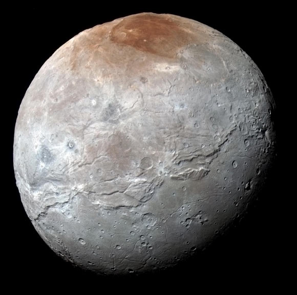 This impressive view of Charon was captured on July 14, 2015. Charon’s color palette is not as diverse as Pluto’s; most striking is the reddish north (top) polar region, informally named Mordor Macula. Image credit: NASA / Johns Hopkins University Applied Physics Laboratory / Southwest Research Institute.