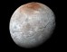 This impressive view of Charon was captured on July 14, 2015. Charon’s color palette is not as diverse as Pluto’s; most striking is the reddish north (top) polar region, informally named Mordor Macula. Image credit: NASA / Johns Hopkins University Applied Physics Laboratory / Southwest Research Institute.
