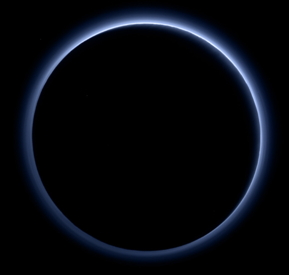 New Horizons looks toward the night side of Pluto and sees sunlight scattering through the periphery of the dwarf planet’s atmosphere and forming a ring of blue color. This image was generated by software that combines information from blue, red and near-infrared images to replicate the color a human eye would perceive as closely as possible. Image credit: NASA / Johns Hopkins University Applied Physics Laboratory / Southwest Research Institute.