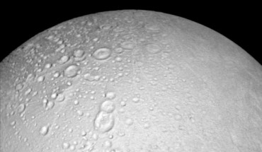 This image from Cassini shows battered terrain around the north pole of Enceladus. Craters crowd and overlap each other, each one recording an impact in the moon’s distant past. The moon’s north pole lies approximately at the top of this image. North on Enceladus is up. The view was acquired at a distance of 4,000 miles (6,000 km) from Enceladus and at a Sun-Enceladus-spacecraft, or phase, angle of 8 degrees. Image credit: NASA / JPL-Caltech / Space Science Institute.