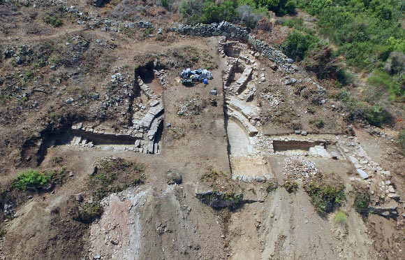 An aerial view of the bouleuterion recently discovered at the site of Antiochia ad Cragum. Test trenches reveal, among other things, a curved marble bench for dignitaries, supports for wooden seats for a general audience and a marble-paved orchestra area. Image credit: Michael Hoff / University of Nebraska-Lincoln. 