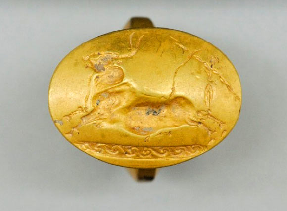 This gold ring with a Cretan bull-jumping scene was one of four solid-gold rings found in the tomb. This number is more than found with any other single burial elsewhere in Greece. Image credit: University of Cincinnati.