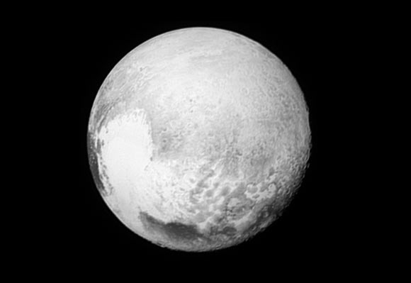 This low-resolution image of Pluto was taken by New Horizons’ Long Range Reconnaissance Imager on July 13, 2015, from a range of 1.03 million miles (1.7 million km). It provides new details to help the New Horizons team map Krun Macula (the prominent dark spot at the bottom of the image) and the complex terrain east and northeast of Tombaugh Regio. Image credit: NASA / Johns Hopkins University Applied Physics Laboratory / Southwest Research Institute.