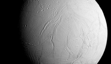 Cassini captured this image of Enceladus as it neared the moon for its closest-ever dive past the moon’s active south polar region. The image was taken in visible light with the spacecraft’s narrow-angle camera on October 28, 2015. The image shows heavily cratered northern latitudes at top, transitioning to fractured, wrinkled terrain in the middle and southern latitudes. The wavy boundary of the moon's active south polar region is visible at bottom, where it disappears into wintry darkness. This view looks towards the Saturn-facing side of Enceladus. The image was taken at a distance of approximately 60,000 miles (96,000 km) from Enceladus and at a Sun-Enceladus-spacecraft, or phase, angle of 45 degrees. Image credit: NASA / JPL-Caltech / Space Science Institute.