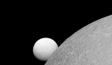 This image, taken with Cassini’s narrow-angle camera on September 8, shows Dione (near) and Enceladus (far). Although these moons are composed of nearly the same materials, Enceladus has a considerably higher reflectivity than Dione. This view looks toward the leading hemisphere of Enceladus. North on Enceladus is up and rotated 1 degree to the right. Image credit: NASA / JPL-Caltech / Space Science Institute.