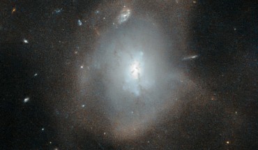 This Hubble image shows the elliptical galaxy LEDA 3087775. In this galaxy, some ribbons of dust notably obscure parts of the conglomerated galaxy’s central, bluish region; those dust lanes could be remnants of the spiral arms of the recently departed galaxies. Image credit: NASA / ESA / Hubble / Judy Schmidt, www.geckzilla.com.