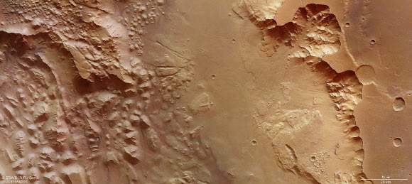 This image focuses on a section of Aurorae Chaos on Mars. Vast volumes of water once flooded through this deep chasm on the planet that connects Valles Marineris to the planet’s northern lowlands. The image was taken by Mars Express’ High Resolution Stereo Camera on July 16, 2015. The image was acquired using the nadir channel of the camera, which is directed vertically down onto the surface of Mars. Image credit: ESA / DLR / FU Berlin / CC BY-SA 3.0 IGO.