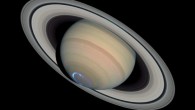 Photomontage of Saturn with a false-color image of UV aurora taken with Hubble’s Imaging Spectrograph on January 24, 2004, superimposed on an image of visible light taken with Hubble’s Advanced Camera for Surveys on March 22, 2004. Image credit: NASA / ESA / J. Clarke, Boston University / Z. Levay, STScI.