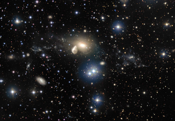 Among the debris surrounding NGC 5291 (center) is a rare dwarf galaxy, NGC 5291N (appears as a bright clump towards the right of the image). NGC 5291 is currently interacting with MCG-05-33-005 - or the Seashell Galaxy - the unusual comma-shaped galaxy appearing to leech off NGC 5291’s luminous core. Image credit: ESO.