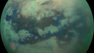 This composite image shows an infrared view of Titan. In this image blue represents wavelengths centered at 1.3 microns, green represents 2.0 microns, and red represents 5.0 microns. A view at visible wavelengths would show only Titan’s hazy atmosphere; the near-infrared wavelengths in this image allow Cassini’s vision to penetrate the haze and reveal the moon’s surface. The view looks toward terrain that is mostly on the Saturn-facing hemisphere of Titan. Image credit: NASA / JPL-Caltech / Space Science Institute.