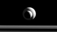 Like a cosmic bull’s-eye, the two Saturnian moons line up almost perfectly for Cassini’s narrow-angle camera. Image credit: NASA / JPL-Caltech / Space Science Institute.