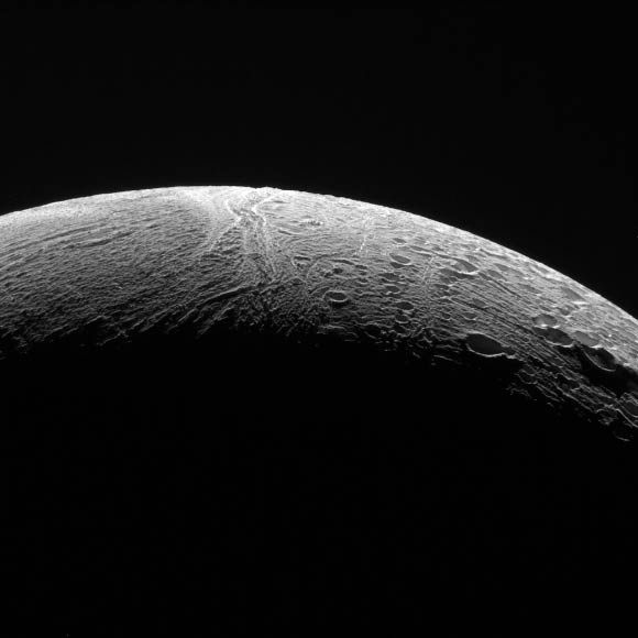 Cassini peered out over Enceladus’ northern territory, capturing this view of two different terrain types. A region of older terrain covered in craters that have been modified by geological processes is seen at right, while at left is a province of relatively craterless, and presumably more youthful, wrinkled terrain. At the time of this image, the spacecraft was roughly 21,000 miles (34,000 km) from Enceladus. Image credit: NASA / JPL-Caltech / Space Science Institute.