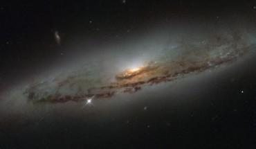 This image from Hubble’s WFPC2 camera shows the spiral galaxy NGC 4845. The galaxy’s orientation clearly reveals the galaxy’s striking spiral structure: a flat and dust-mottled disc surrounding a bright galactic bulge. Image credit: NASA / ESA / Hubble / S. Smartt, Queen's University Belfast.