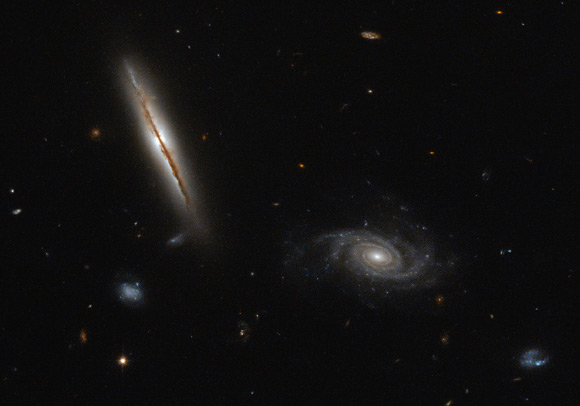 Visible in this image are galaxies within the galaxy cluster Abell 428: the jet-producing spiral galaxy LEDA 97372 (left) and the spiral galaxy [LOY2001] J031549.8-190623 (right). Image credit: NASA / ESA / Hubble / Judy Schmidt, www.geckzilla.com.
