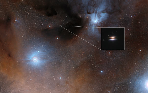This image shows part of the Rho Ophiuchi region; a much enlarged close-up infrared view of the young star J1628 from the Hubble Space Telescope is shown as an insert. Image credit: NASA / ESA / Digitized Sky Survey 2.