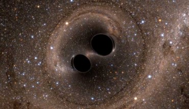The collision of two black holes is seen in this still from a computer simulation. Image credit: SXS.