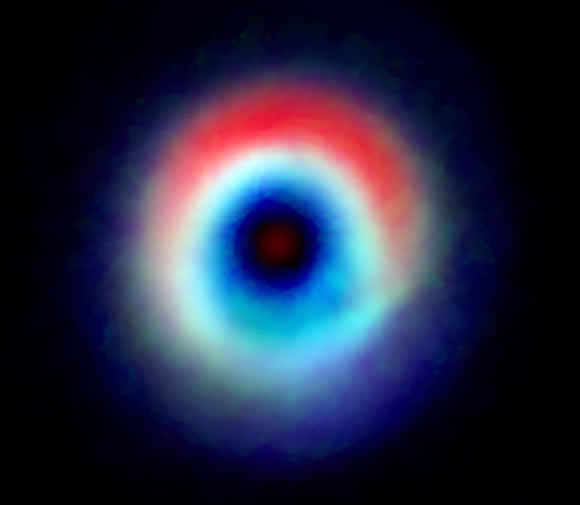 This composite image of HD 142527 shows a distinctive arc of dust (red) and a ring of carbon monoxide (blue and green). Image credit: Andrea Isella / Rice University / B. Saxton / NRAO / AUI / NSF / ALMA / ESO / NAOJ.