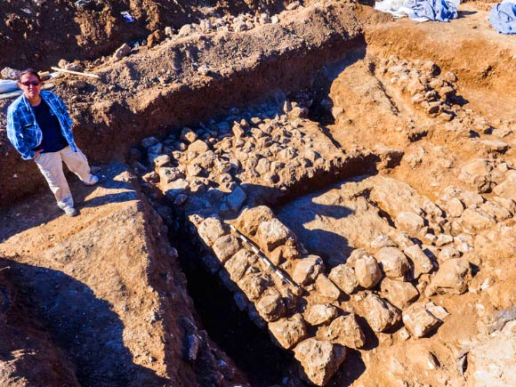 Dr. Lupo next to the remains of a Chalcolithic period building. Image credit: Assaf Peretz / Israel Antiquities Authority.
