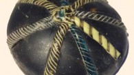 A glass counter decorated with twisted colorful strands was found at the site. Image credit: University of Sheffield.