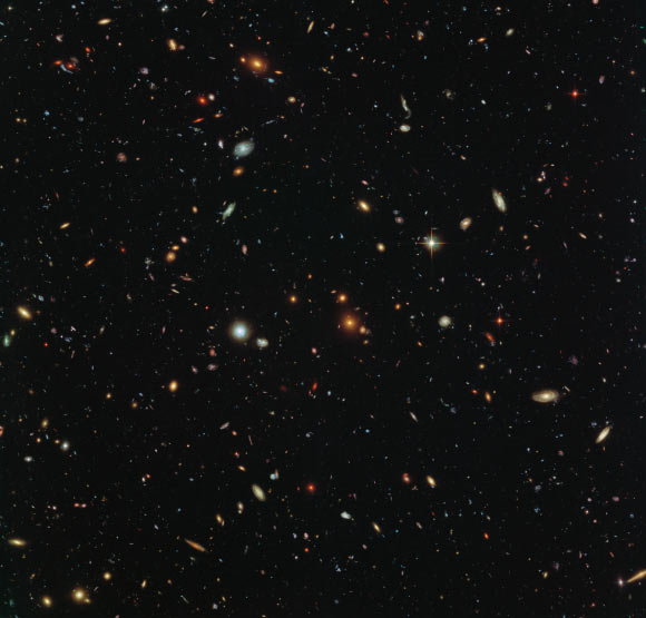 This Hubble image shows thousands of galaxies swimming in the inky blackness of space; a few foreground stars from our Milky Way Galaxy are also visible. Image credit: NASA / ESA / HST Frontier Fields Team / STScI / Judy Schmidt, www.geckzilla.com.