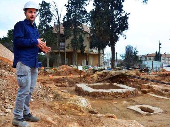 Dr. Wiegmann views a 1,600-year-old winepress uncovered in Jerusalem. Image credit: Israel Antiquities Authority.