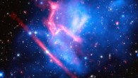 This composite image of the galaxy cluster MACS J0717 was made by combining data from NASA’s Chandra and Hubble space telescopes, and NRAO’s Jansky Very Large Array. Image credit: NASA / ESA / CXC / NRAO / AUI / NSF / STScI / R. van Weeren, Harvard-Smithsonian Center for Astrophysics / J. Lotz, STScI / HFF Team.