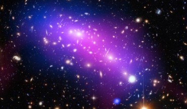 This image of the galaxy cluster MACS J0416 combines data from three telescopes - Hubble (showing the galaxies and stars), Chandra (diffuse emission in blue), and the Jansky Very Large Array (diffuse emission in pink). MACS J0416 acts as a powerful natural lens by bending and magnifying the light of far-more-distant objects behind it. Image credit: NASA / ESA / CXC / NRAO / AUI / NSF / STScI / G. Ogrean, Stanford University / J. Lotz, STScI / HFF Team.