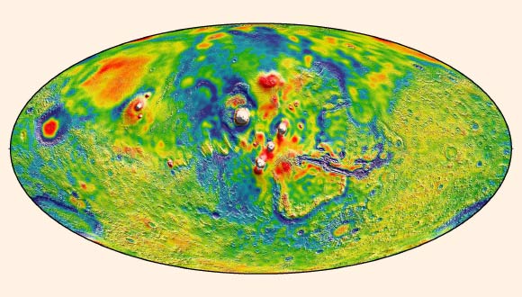 This view of the Martian gravity map shows the Tharsis volcanoes and surrounding flexure: the white areas in the center are higher-gravity regions produced by the massive Tharsis volcanoes, and the surrounding blue areas are lower-gravity regions that may be cracks in the crust. Image credit: MIT / UMBC-CRESST / GSFC.