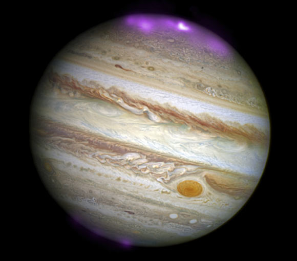 Solar storms are triggering X-ray auroras on Jupiter that are about 8 times brighter than normal over a large area of the planet. These Jovian auroras are hundreds of times more energetic than Earth’s aurora borealis. This composite image with data from NASA’s Chandra and Hubble shows Jupiter and its aurora during a giant solar storm on October 2, 2011. Image credit: X-ray – NASA / CXC / UCL / W. Dunn et al.; optical – NASA / STScI.