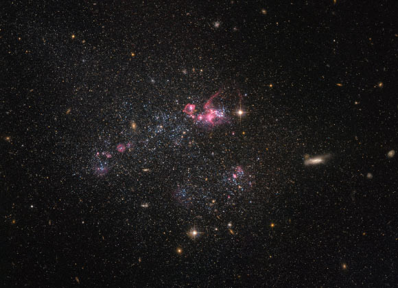 This image, taken by NASA’s Hubble Space Telescope, shows an irregular dwarf galaxy known as UGC 4459, lying about 12 million light-years away in the constellation Ursa Major. Image credit: NASA / ESA / Hubble / Judy Schmidt, www.geckzilla.com.