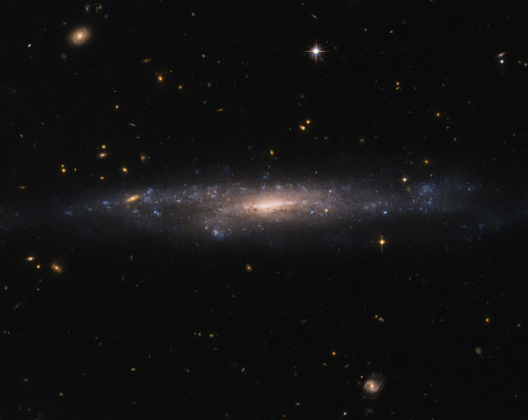 This Hubble image shows the low surface brightness galaxy UGC 477, which lies in the constellation of Pisces, about 115 million light-years away. Image credit: NASA / ESA / Hubble / Judy Schmidt, www.geckzilla.com.